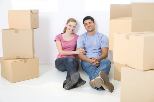 Removal company van and moving team in a Leytonstone residential street