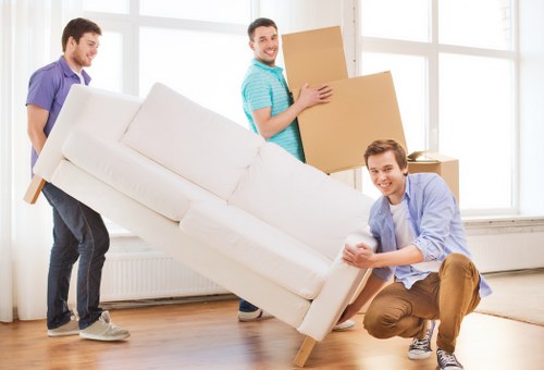 Professional movers handling desks and equipment for a Leytonstone business move