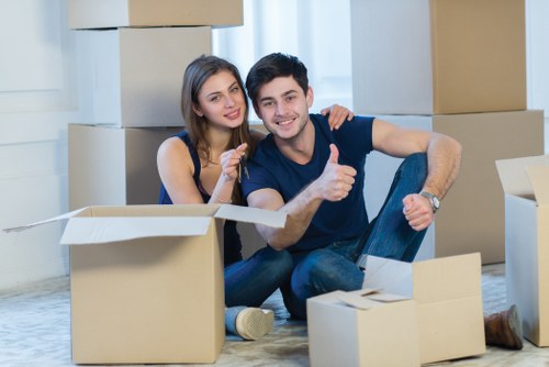 Furniture and boxes being packed into a moving truck
