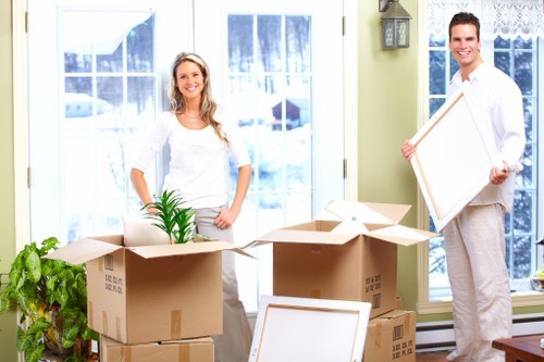 Professional movers carrying furniture in a Leytonstone flat move